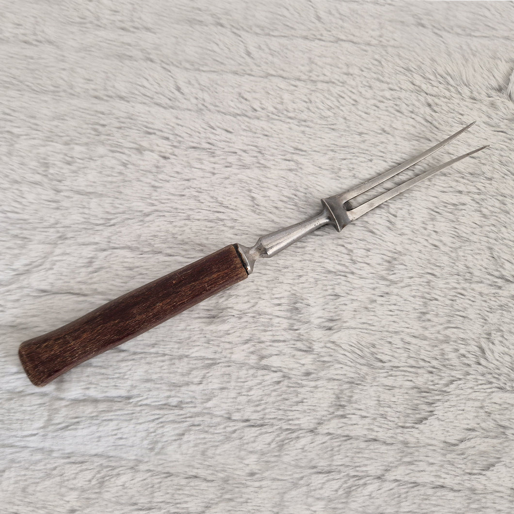 Antique steel meat fork with wooden handle and steel cuff