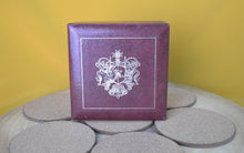 Load image into Gallery viewer, Charming Set of 7 Vintage Round Red &amp; Gold Coasters with Coat of Arms Design
