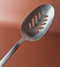 Load image into Gallery viewer, Vintage Boots slotted stainless steel serving spoon black plastic handle , Old Kitchenalia
