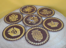 Load image into Gallery viewer, Charming Set of 7 Vintage Round Red &amp; Gold Coasters with Coat of Arms Design
