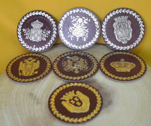 Load image into Gallery viewer, Charming Set of 7 Vintage Round Red &amp; Gold Coasters with Coat of Arms Design
