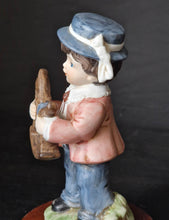 Load image into Gallery viewer, Joy Of time by Leonardo Figurine, Boy with rocking horse toy ceramic figure with wooden plinth base
